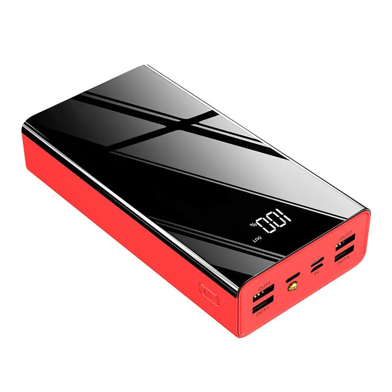 Large black 40000mAh power bank with LCD display showing battery percentage, placed next to a charging cable.