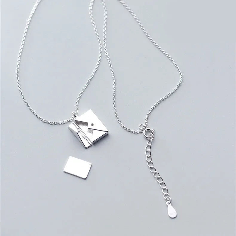 Titanium steel envelope pendant necklace with chain on a woman's neck, gold finish