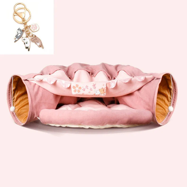 Collapsible cloth cat tunnel in Pink colour with visible opening, measuring 45x50x22 cm, on wooden floor