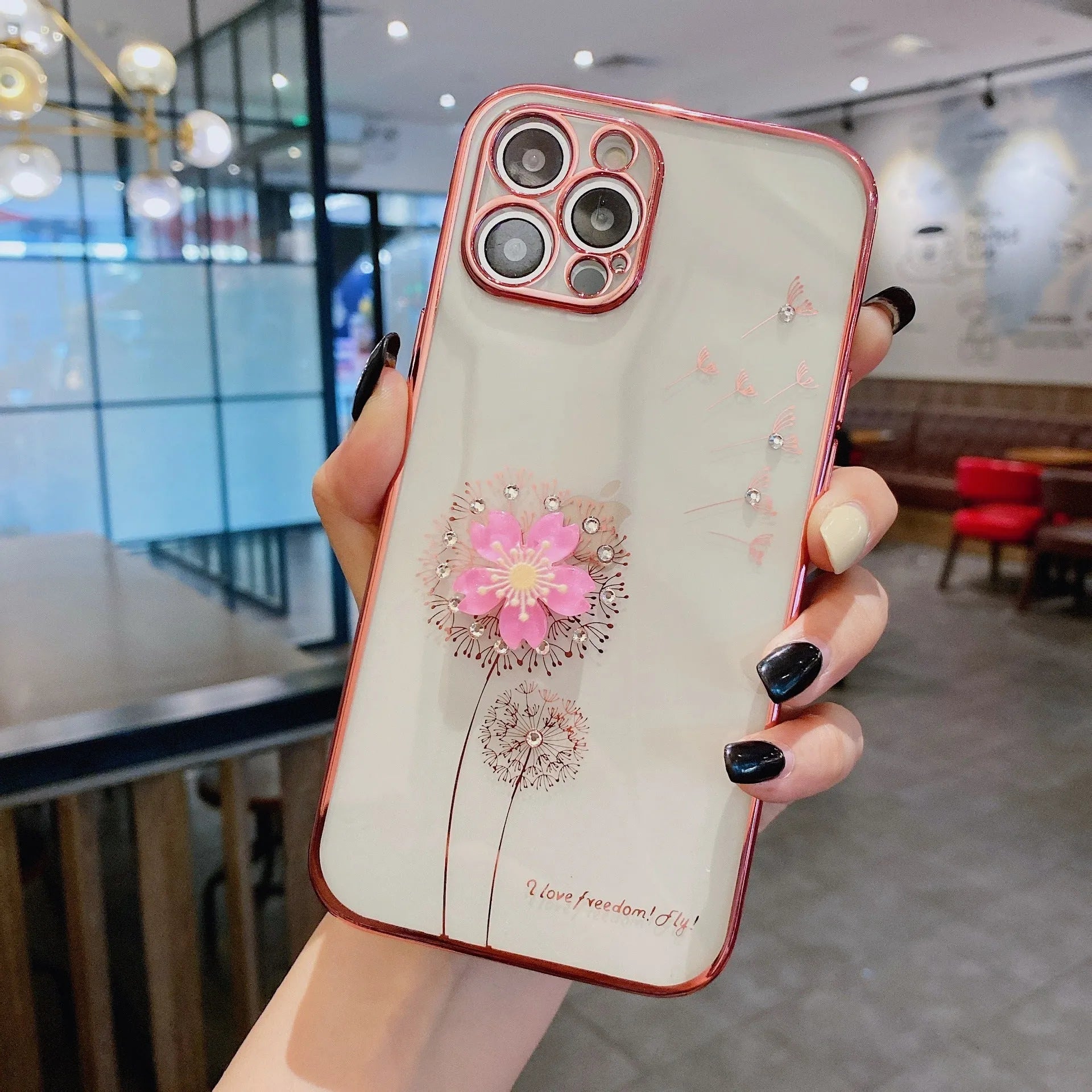 Green iPhone case with 3D floral design and extended kickstand on a table