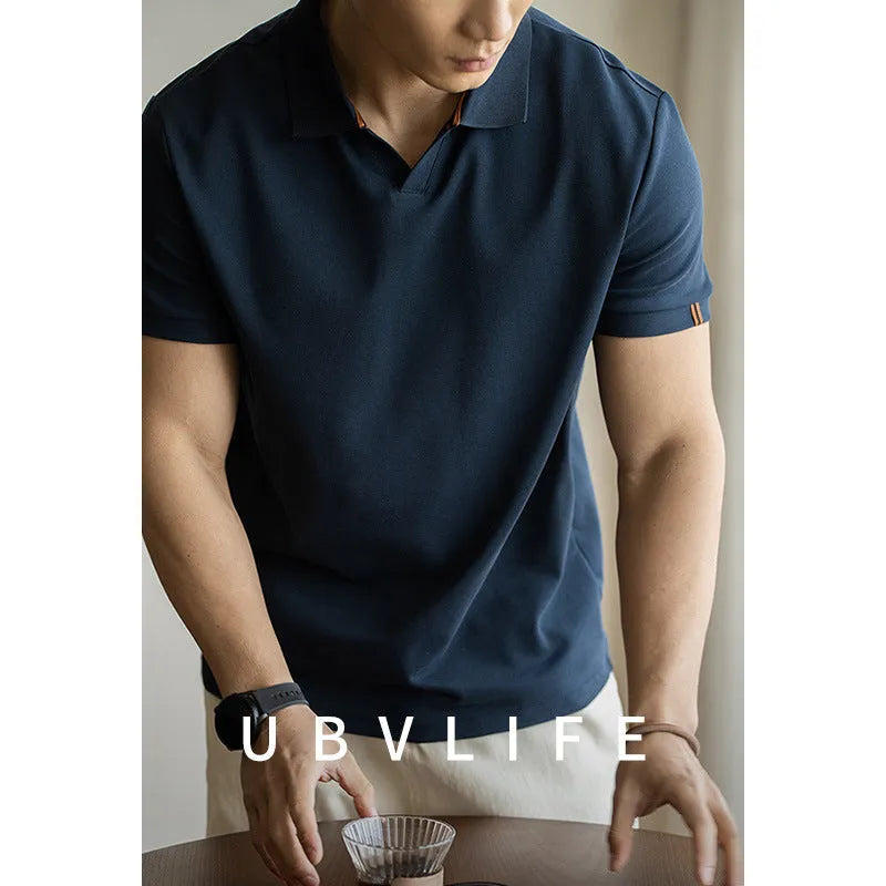 Blue short-sleeved polo shirt on a hanger, showing regular fit and cotton-polyester fabric blend.