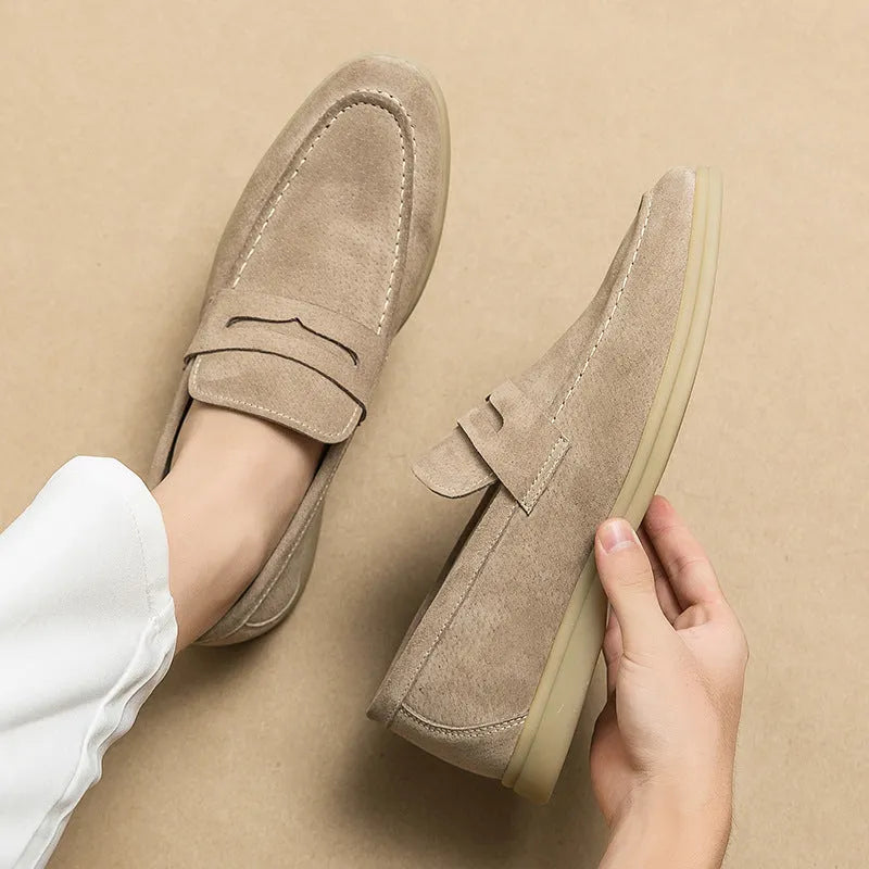 Men's black leather slip-on casual shoes with a round toe and rubber sole on a white background.