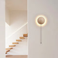 Yellow semicircle cave stone wall lamp with wooden base, shown as a bedside or stair light.