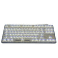 Universal transparent plastic 132-key keyboard key cap set laid out on a table.