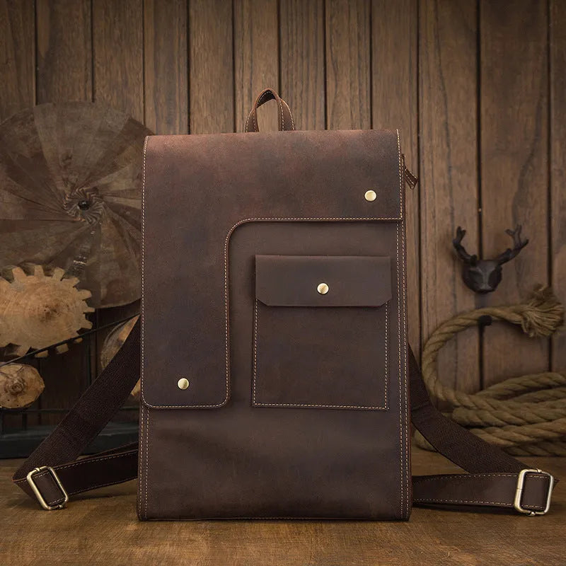 Dark brown genuine leather travel bag with shoulder straps and organised internal compartments