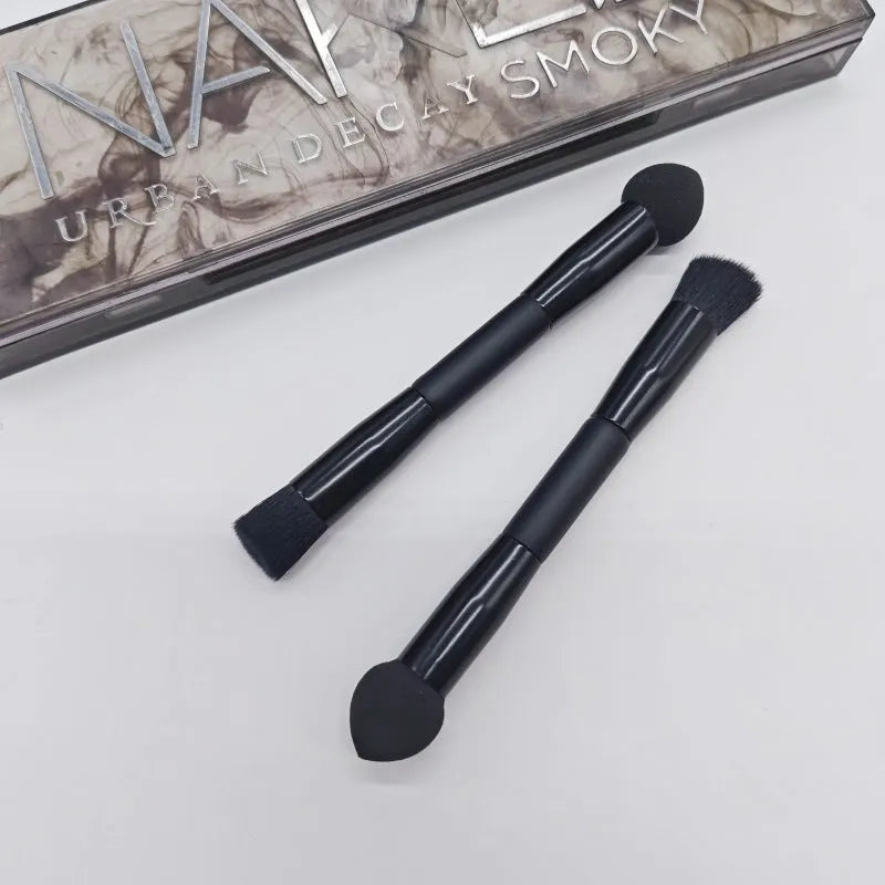 Double-headed concealer brush with black wooden handle, artificial fibre bristles, and angled sponge tip.