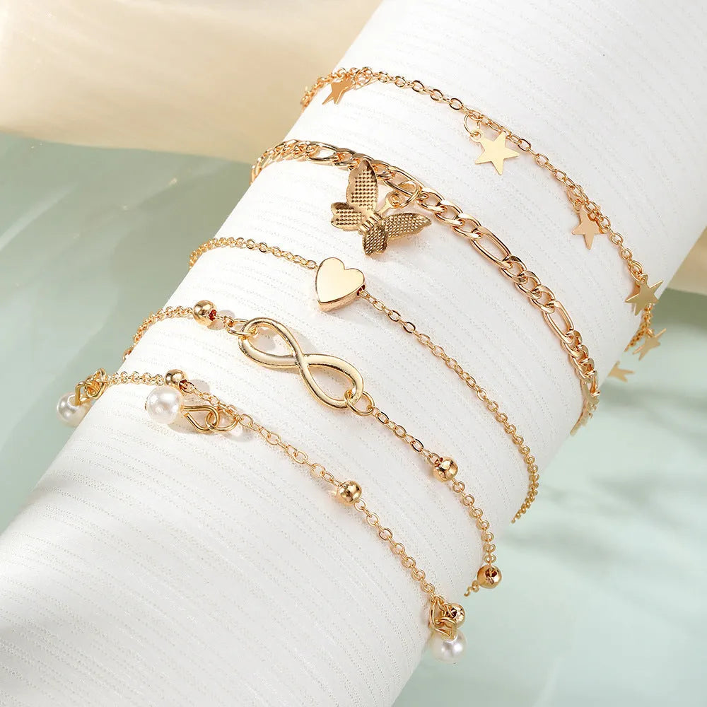 Butterfly pearl heart women's anklet set showing four layered alloy foot chains with butterfly and heart charms