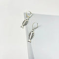 Fishbone pendant necklace and matching earrings set with adjustable chain on grey background