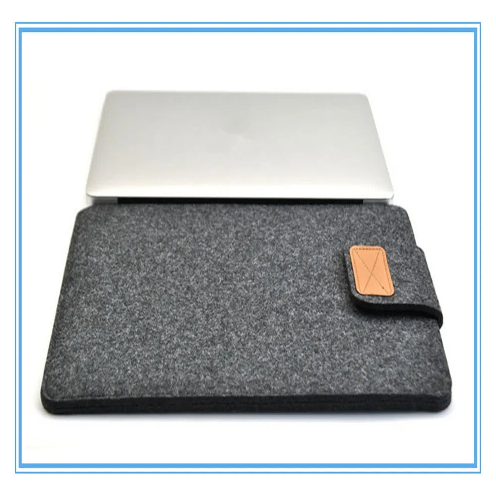 Dark grey plush felt vertical clutch laptop bag showing clamshell opening and structured interior.