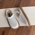 Beige linen slip-on hole shoes with mesh lining and a soft rubber sole, shown in a low-top style.