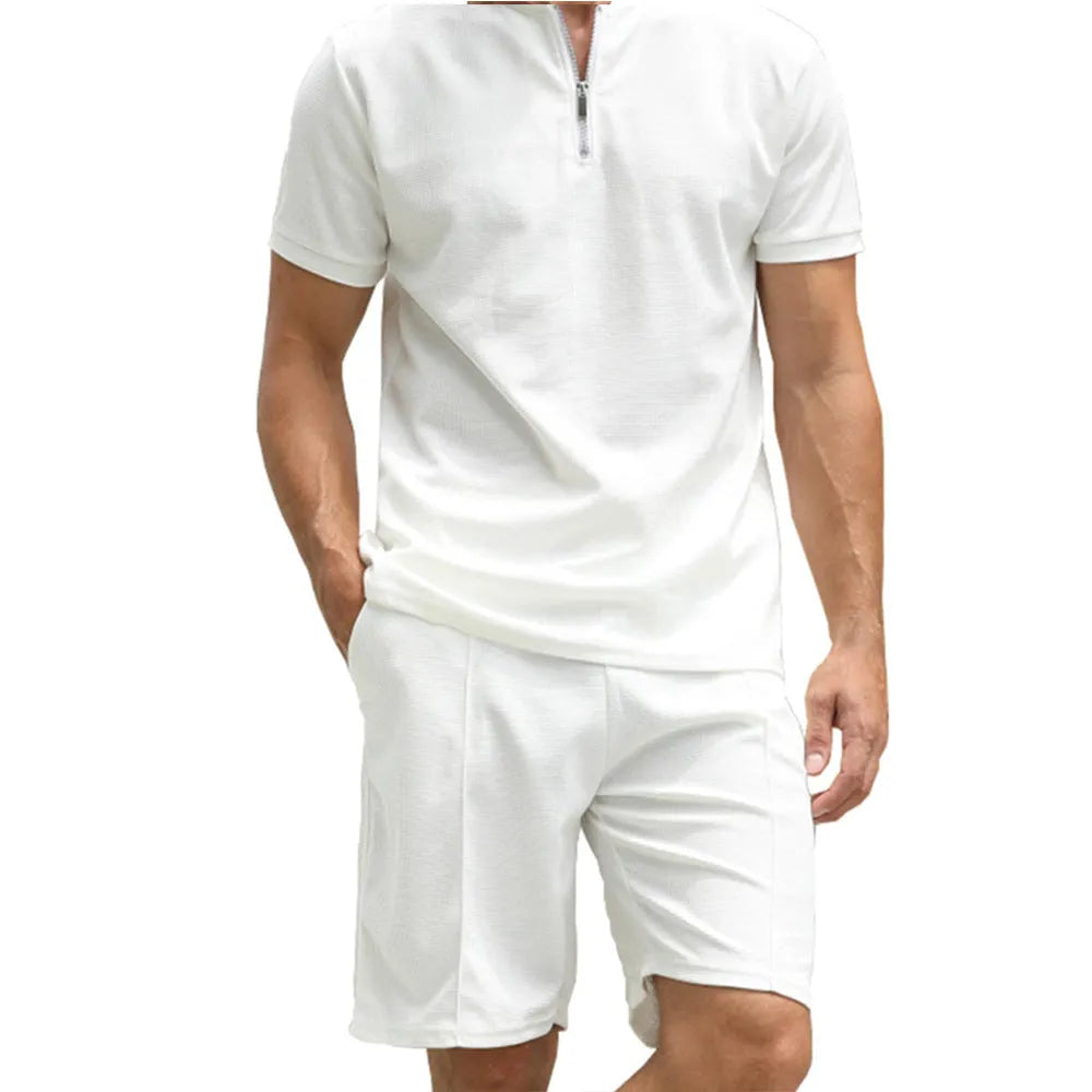 Men's solid colour polo shirt and trouser two-piece set in textured fabric.