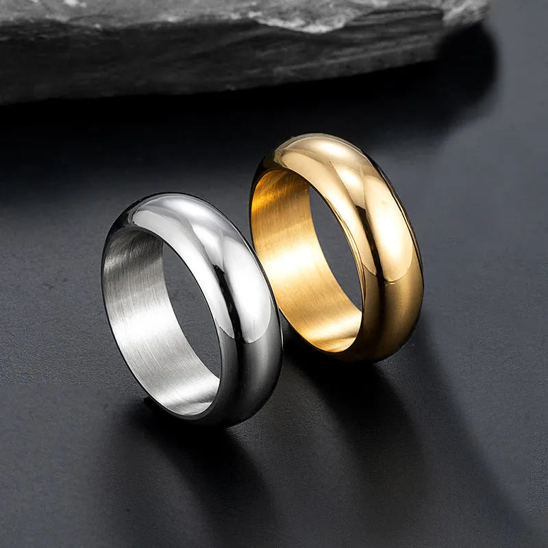 Glossy electroplated titanium steel ring in gold, black and steel colours showing metallic finish
