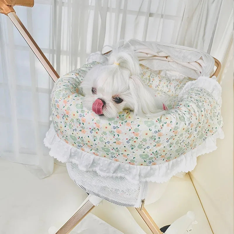 A green grey striped towel, cushion, and pillow set for a pet stroller, shown removed and ready for washing.