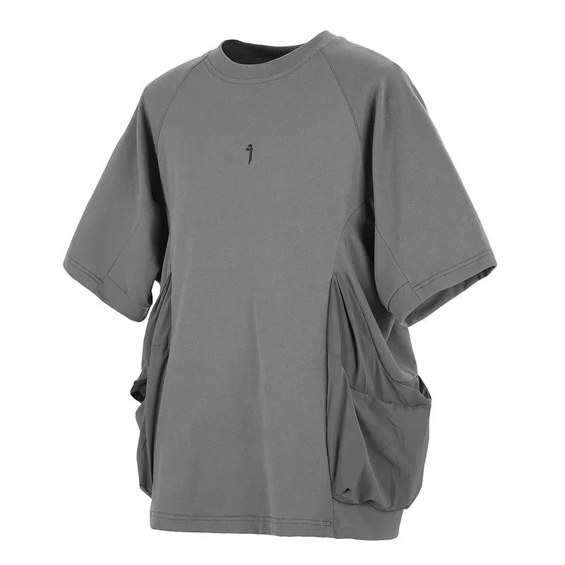 A man's loose black cotton T-shirt with large chest pockets and short sleeves.