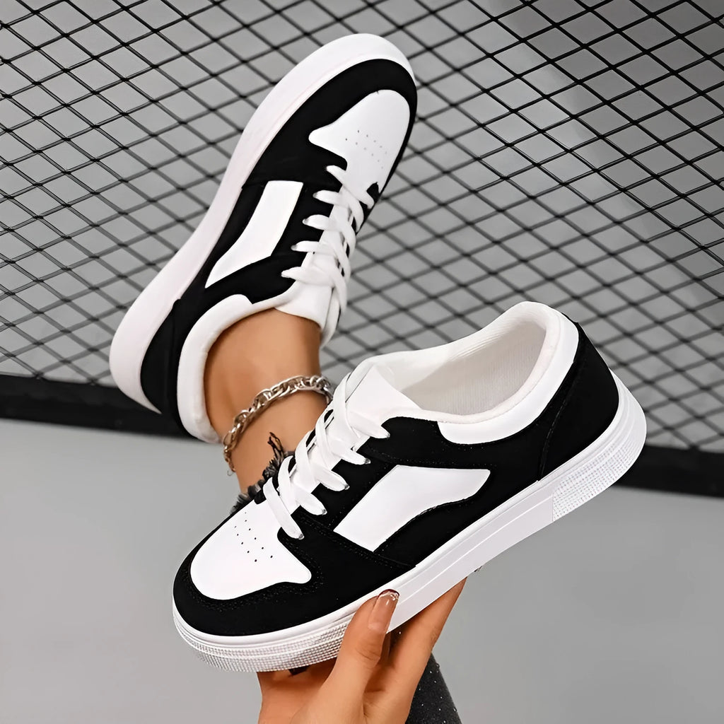Black women's casual sports shoes with round toe, flat rubber sole, and lace-up front