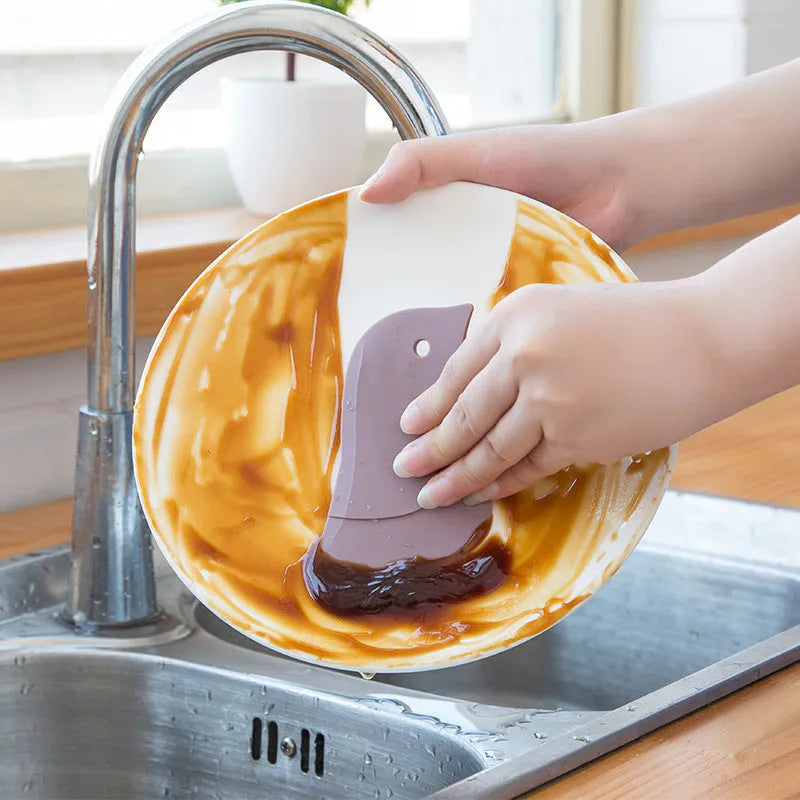 Penguin-shaped soft kitchen scraper for cleaning plates and removing food stains