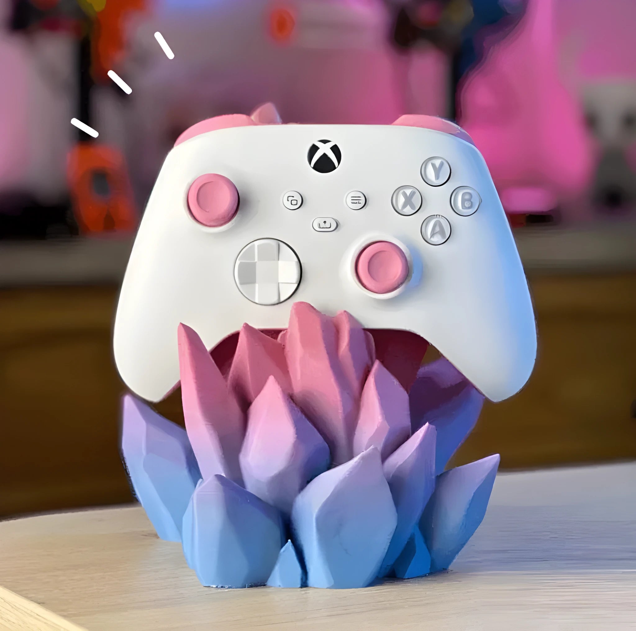 3D printing gamepad bracket in gradient colour, 20cm x 15cm x 10cm, on a desk beside a console