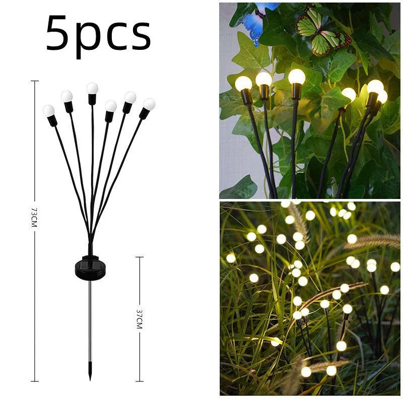 Solar-powered LED firefly garden spike light with multiple heads and a press-in ground plug on grass.