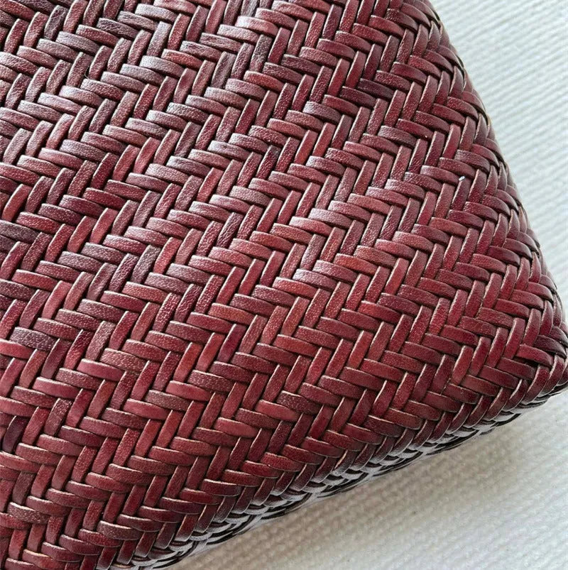 Brown handmade woven leather tote bag with a three-dimensional pocket.