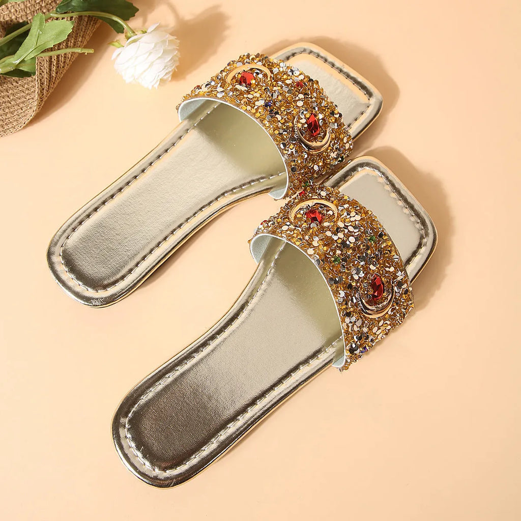 Gold women's flat slippers with rhinestone sequin decoration on the upper.