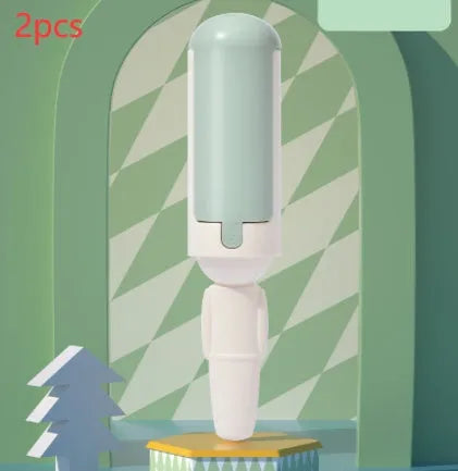 White green reusable pet hair remover roller with non-slip handle on a carpet.