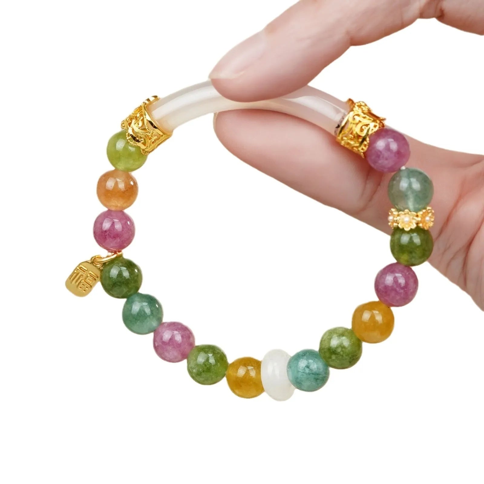 Women's rainbow tourmaline half bracelet with electroplated finish showing natural stone colour variations