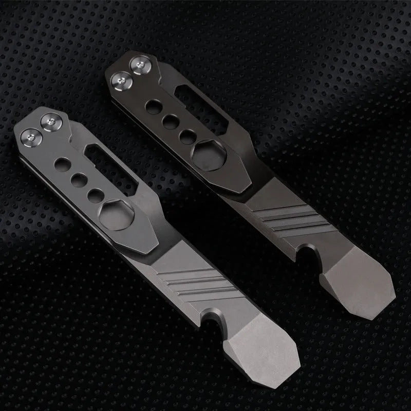 Titanium alloy multi-tool with crowbar edge, screwdriver tip, and bottle opener notches on a stone wash finish background.