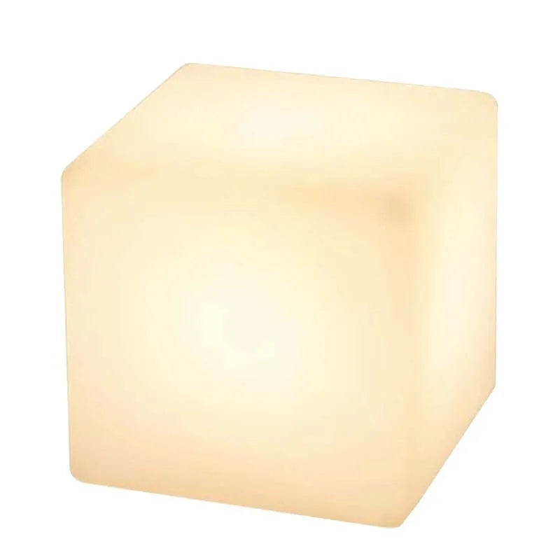 Modern square LED cube light stool in a garden setting, showcasing its clean design and luminous top.