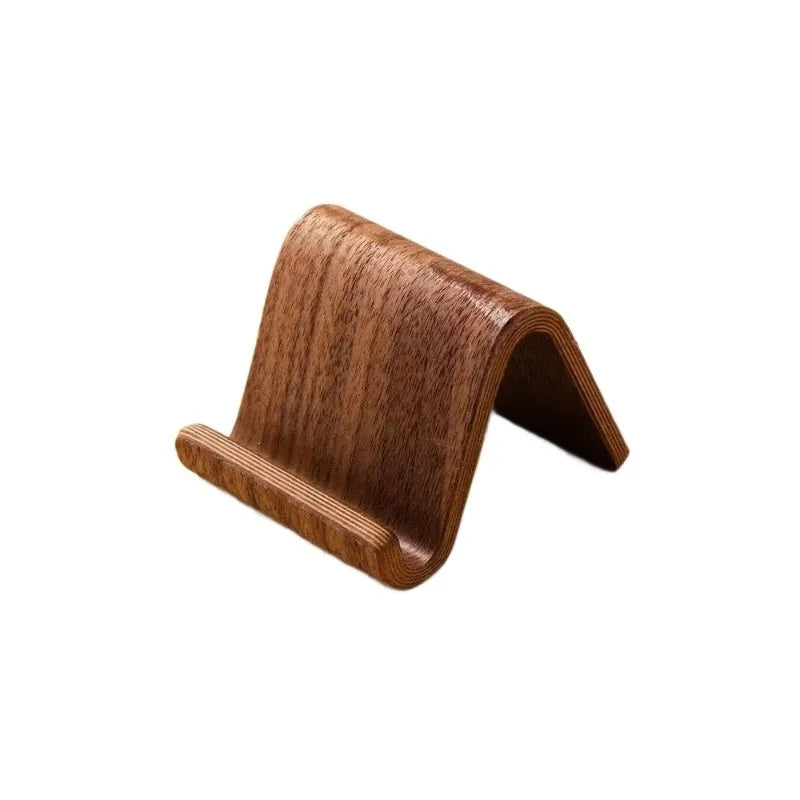Walnut wooden mobile phone bracket on a desk, with a smartphone placed in the stand