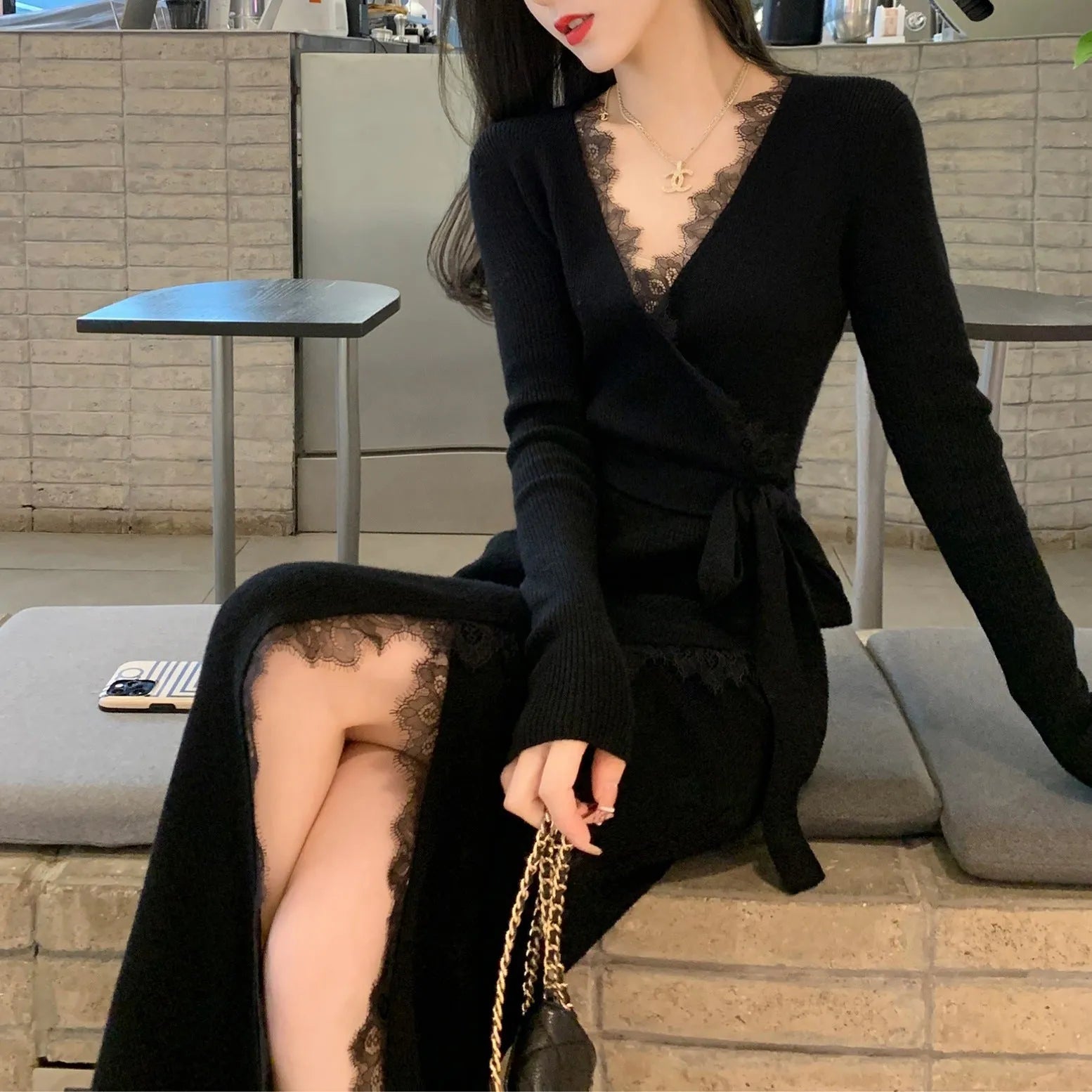 Black knee-length women's skirt with princess-line seams for a slim fit silhouette.