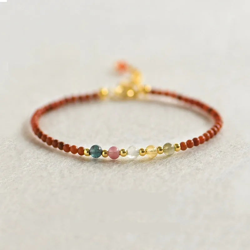 Simple geometric women's bracelet with natural freshwater pearls and crystal details on an elastic rope band.