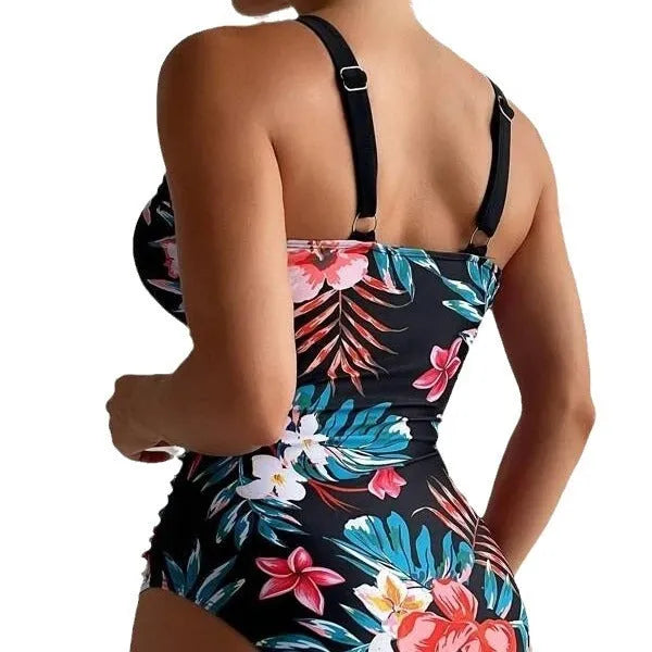 Women's floral pattern backless one-piece swimsuit on a hanger.