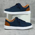 Platform skateboard casual sneaker in beige brown with low top, round toe, and a cross strap detail.