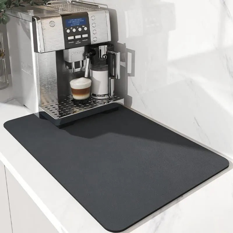 Black square kitchen drain drying mat with anti-slip rubber backing on a countertop