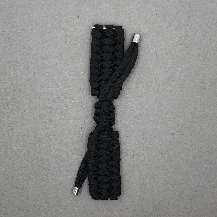 Paracord braided smartwatch strap in black on a watch, showing textured weave and connector lugs.