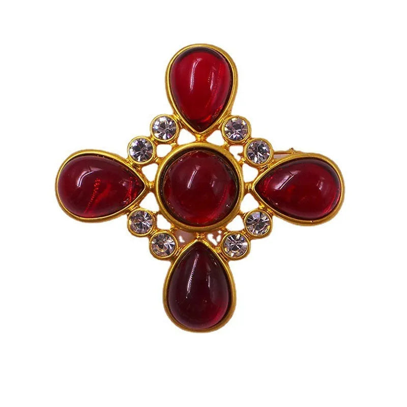 Close-up of a vintage medieval baroque cross brooch in zinc alloy with crystal accents, showing intricate detail.