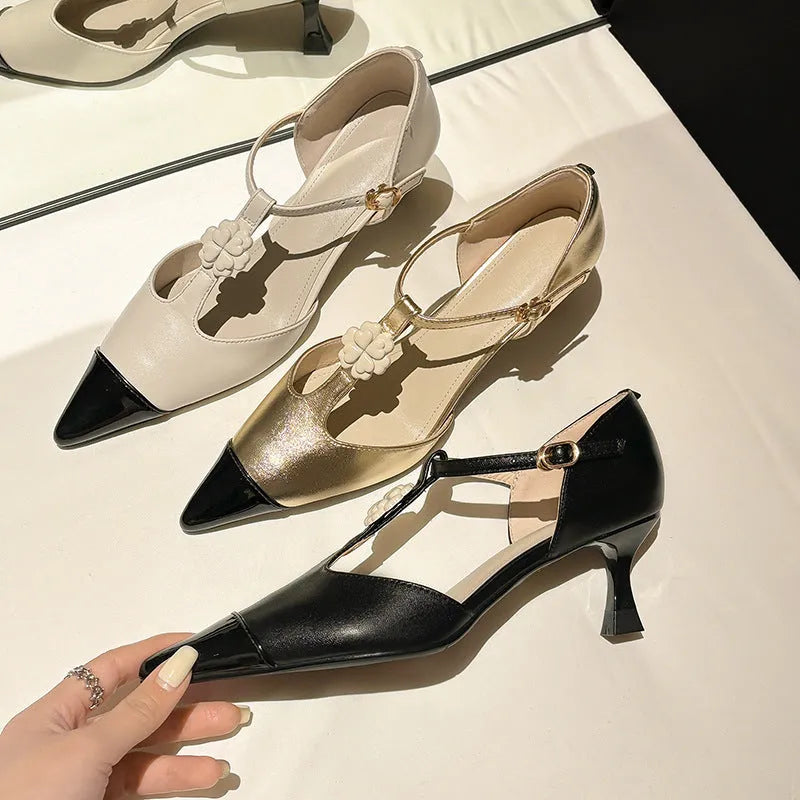 Women's gold stiletto shoe with flower decoration and buckle on sheepskin upper.