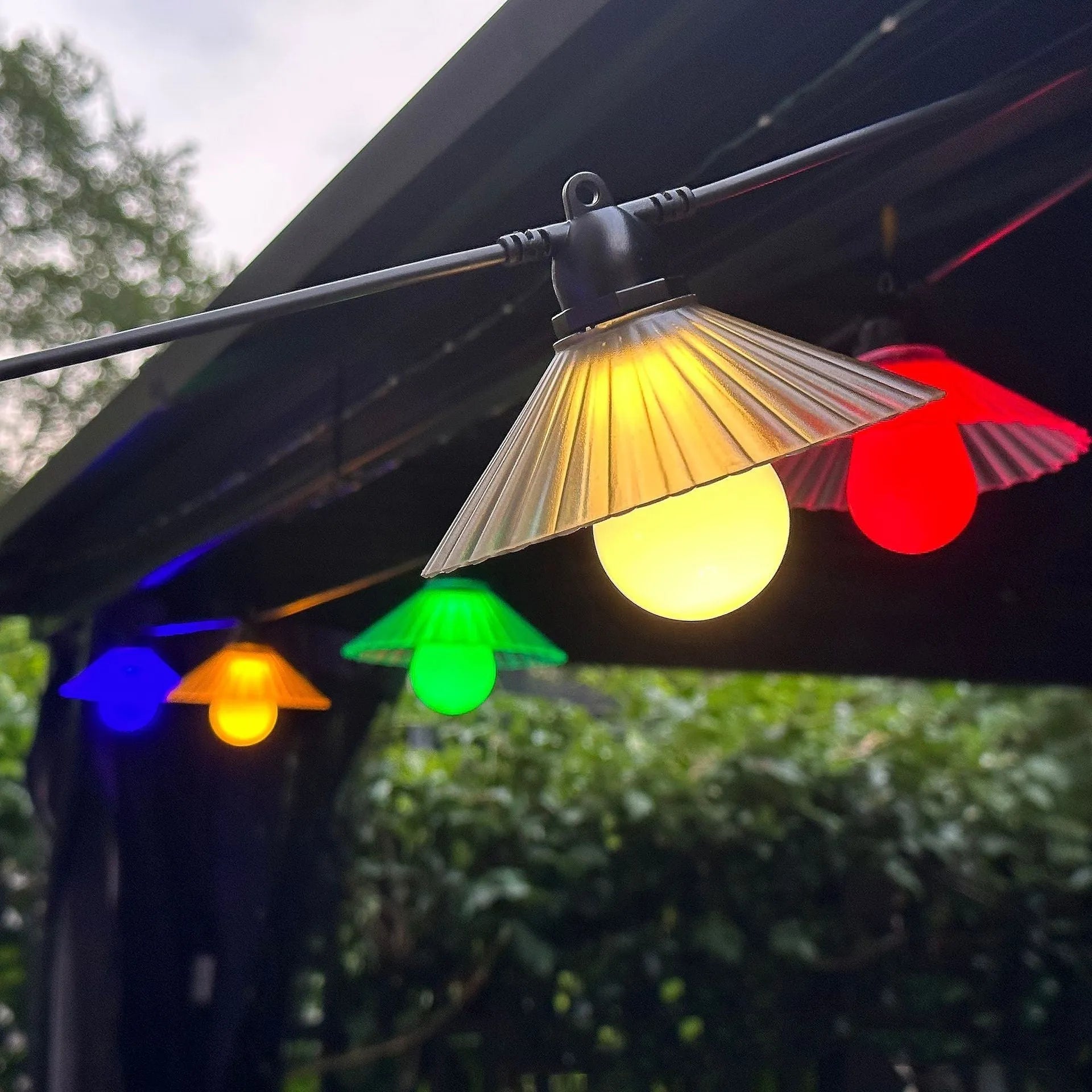 Outdoor LED string lights with flower-shaped bulbs in warm white and multi-colour options.