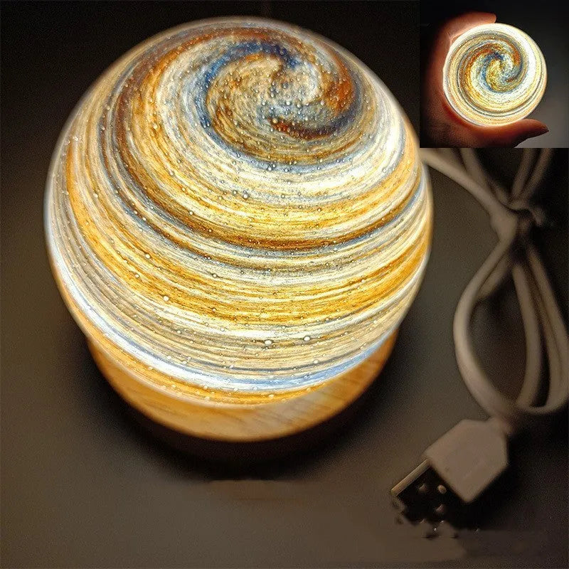 Modern planet-shaped USB night light with dimming on a desk.