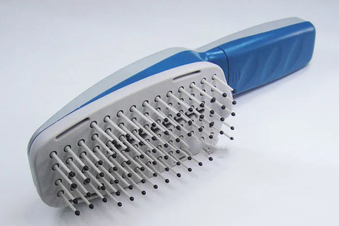 White pet ion comb with removable brush head and 78 comb teeth on a blue background.