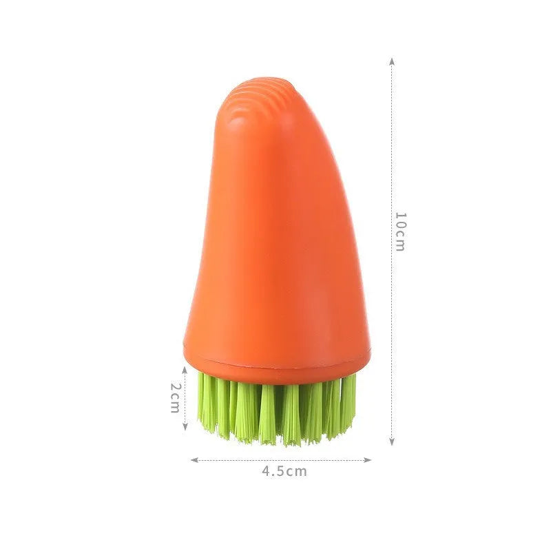 Orange and white carrot-shaped nylon kitchen cleaning brush on a plain background.