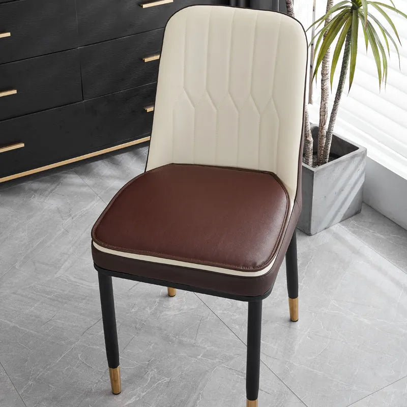Leather horseshoe-shaped seat cushion in beige colour showing thickness and shape