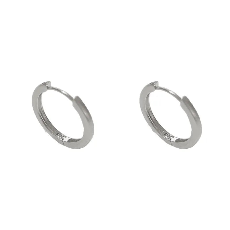 Geometric round women's ear clip with eyelet detail in gold or silver finish