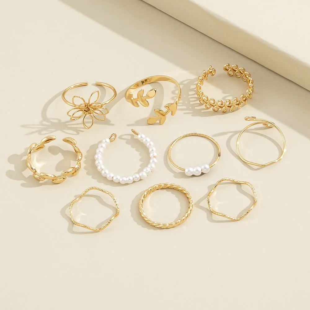 Gold colour openwork flower ring with detailed floral design and glossy electroplated finish
