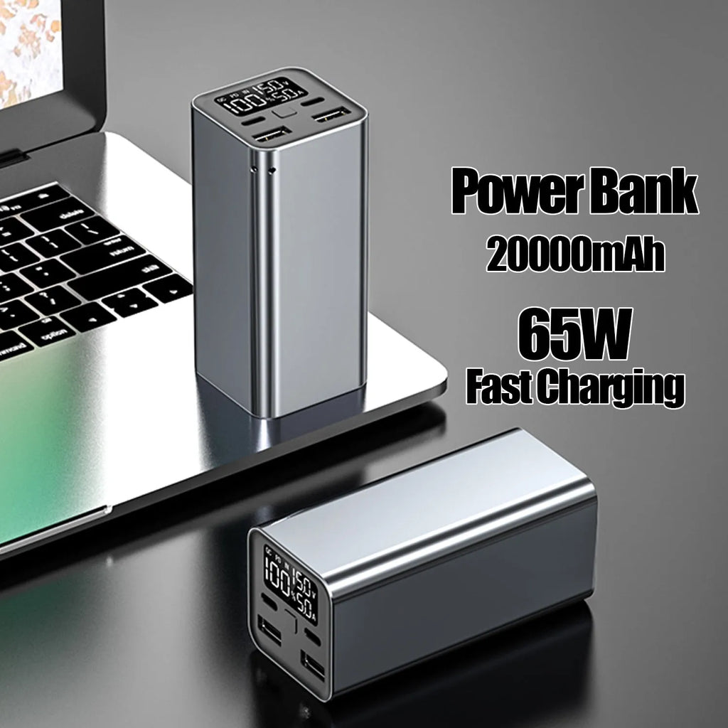 Black metal 65W laptop power bank with 20000mAh capacity showing size next to a laptop.