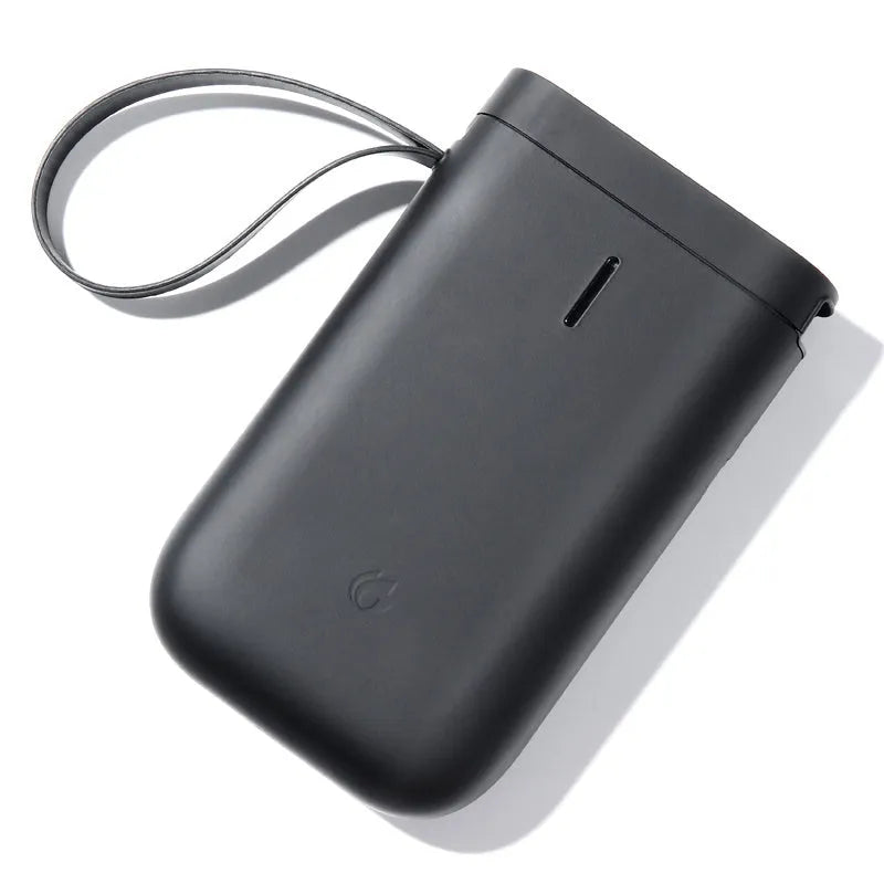 D11 Bluetooth thermal label printer with compact black design shown next to printed labels