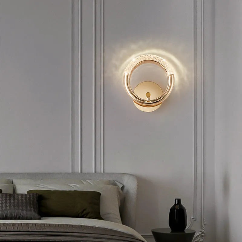 Modern minimalist white wall lamp with an acrylic shade mounted on a plain wall.