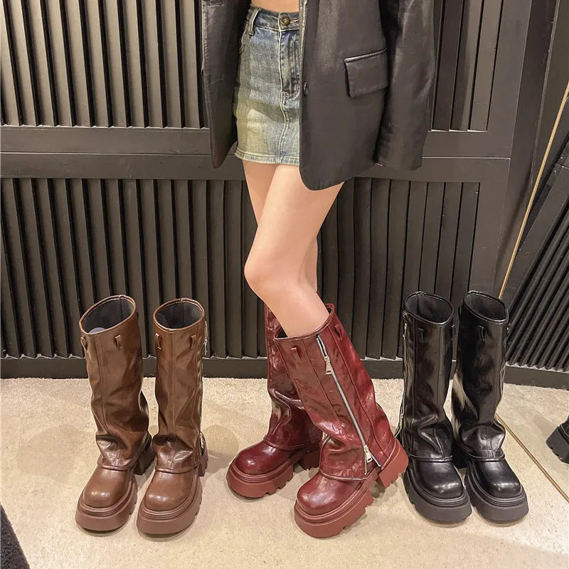 Black platform muffin pants Martin boots with a high cylinder, square heel, and rubber sole.