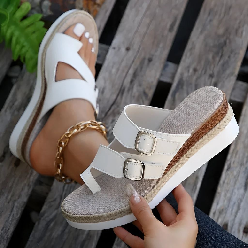 White patent leather wedge sandals with finger fit design and peep toe