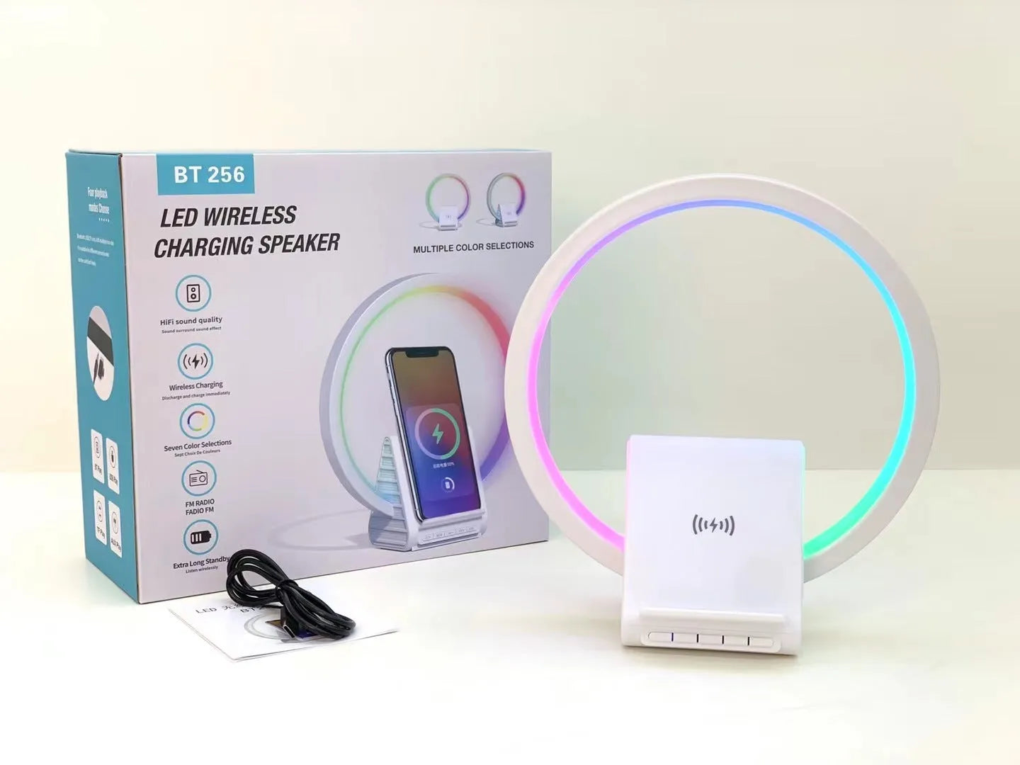 White smart Bluetooth speaker with wireless charging surface and ambient lighting